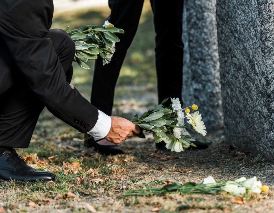 cropped-view-of-senior-man-putting-flowers-near-to-A4V7UQ3.jpg