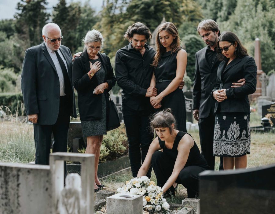 family-laying-flowers-on-the-grave-QKURHPX.jpg family-laying-flowers-on-the-grave-QKURHPX.jpg