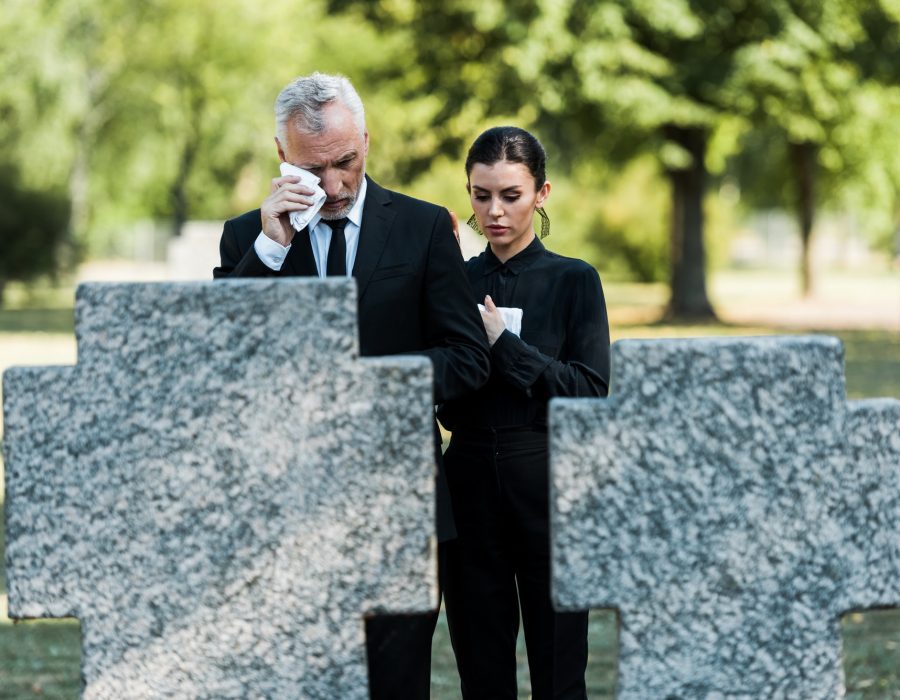 selective-focus-of-upset-man-crying-near-woman-on-funeral.jpg