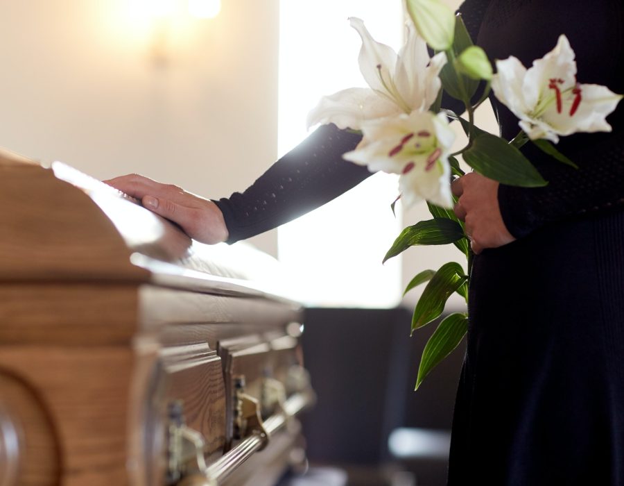 woman-with-lily-flowers-and-coffin-at-funeral.jpg woman-with-lily-flowers-and-coffin-at-funeral.jpg